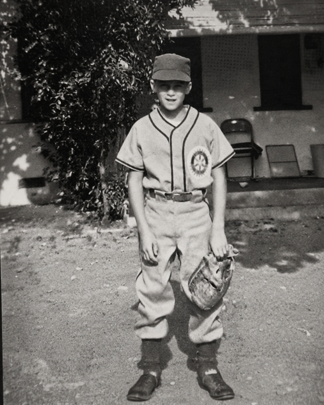 A young ballplayer in the 1950s, glove in hand